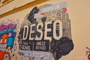 A wall with a bunch of stickers on it — Foto por Christian Hergesell na Unsplash