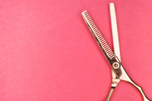 silver scissors on red textile — Foto por Markus Winkler na Unsplash
